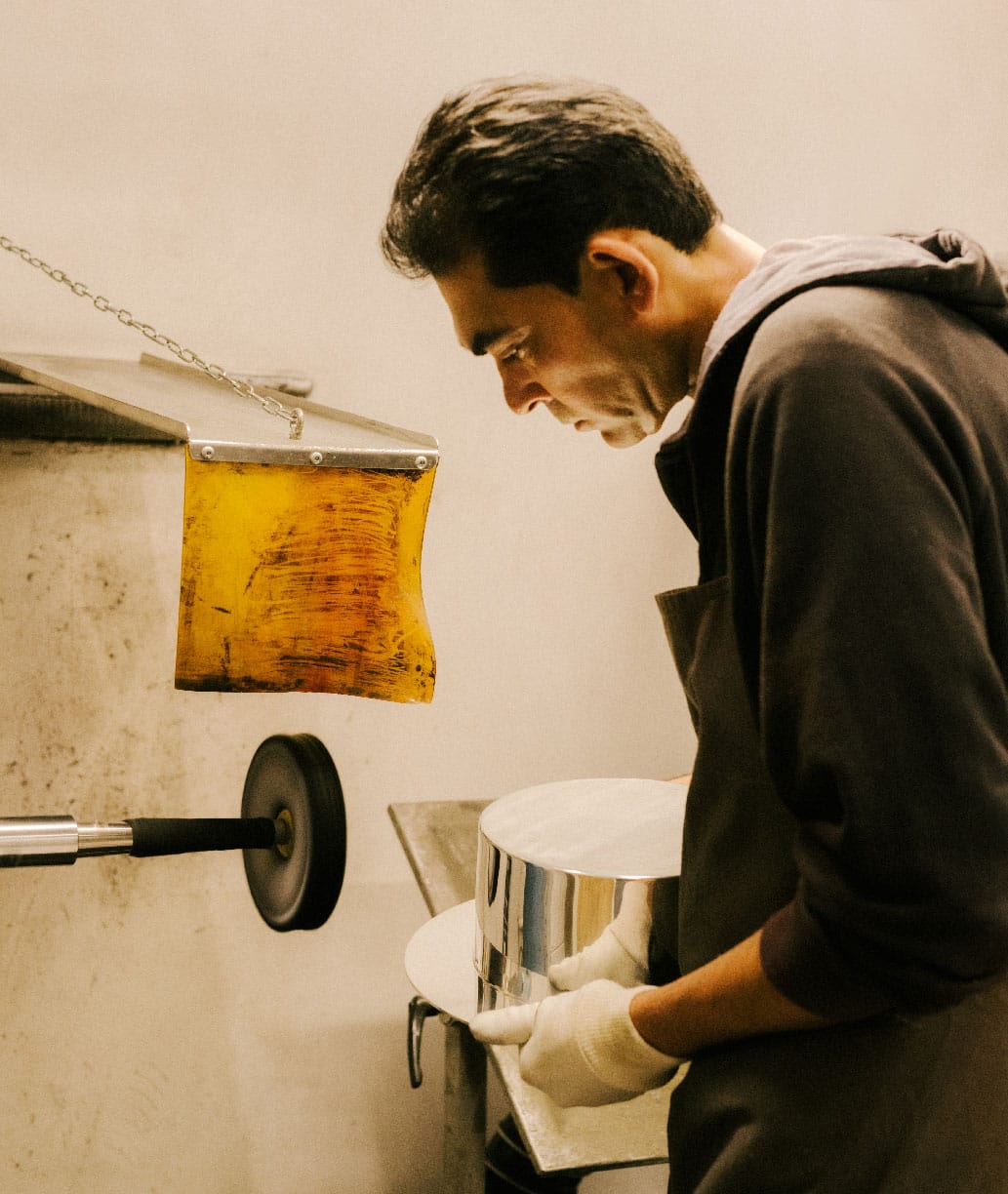 Polishing silversmithing working on a salad bowl from Dinner Service collection by Donald Judd