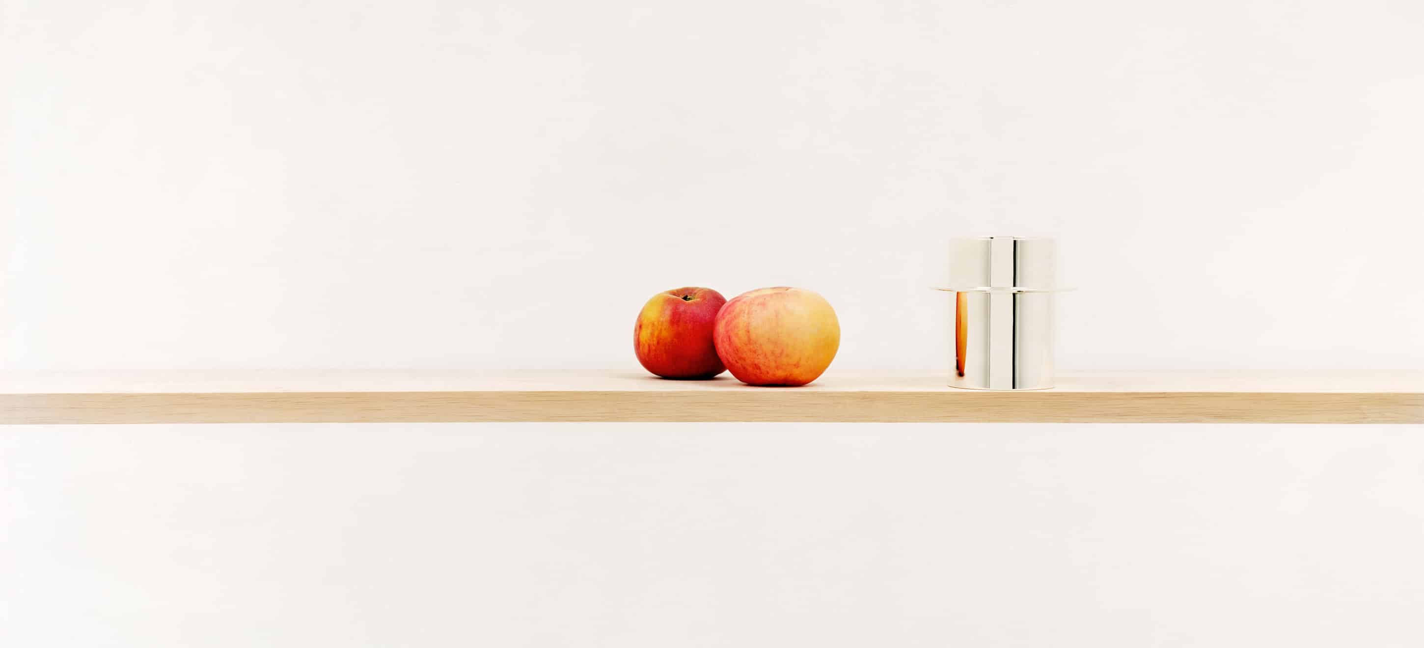 Mug from Dinner Service collection on a shelf standing next to a pair of apples