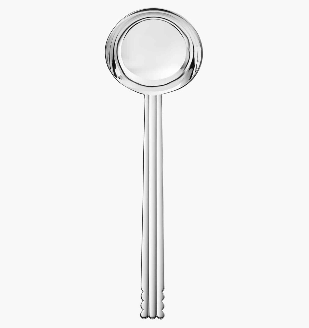 Silver plated soup ladle from the Nantes collection by Puiforcat on a light background.