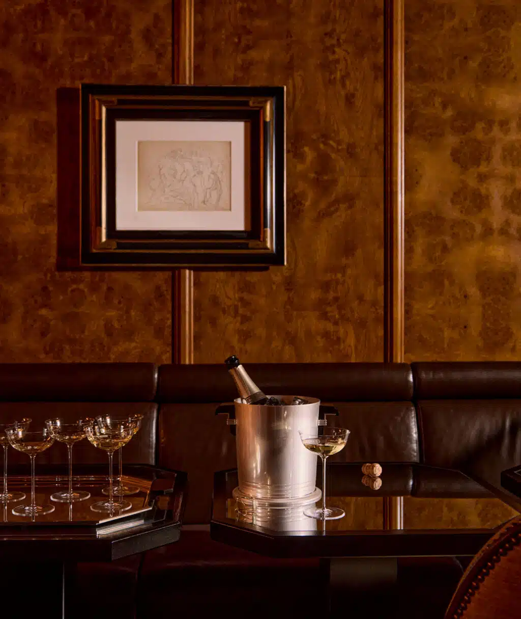 Seau à champagne de la collection Art Déco sur une table en bois avec une coupe à champagne